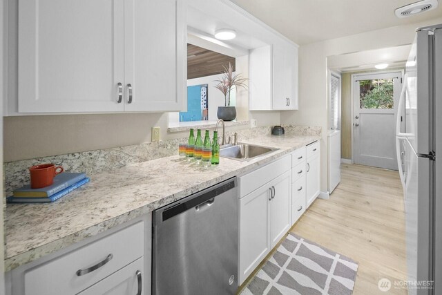 852 NE 194th St, Shoreline, WA 98155 - kitchen featuring dishwasher, freestanding refrigerator, white cabinetry, and light countertops