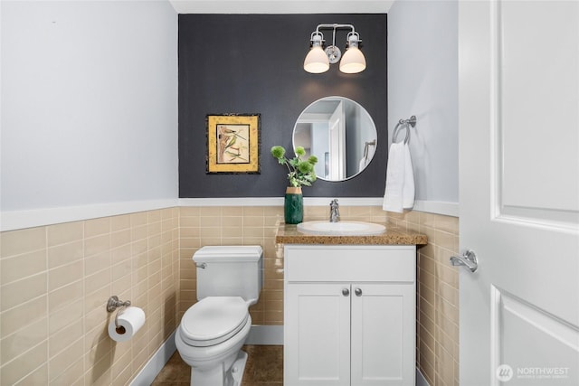 6801 Greenwood Ave N Unit 403, Seattle, WA 98103 - half bathroom featuring tile walls, vanity, a wainscoted wall, and tile patterned floors