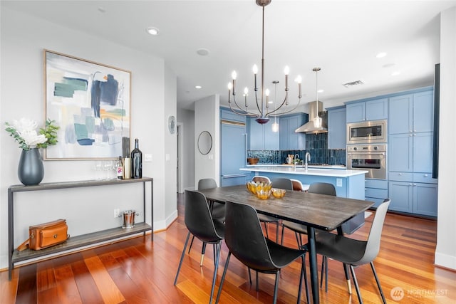 6801 Greenwood Ave N Unit 403, Seattle, WA 98103 - dining space with light wood-style floors, a chandelier, and recessed lighting