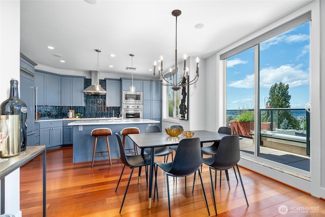 6801 Greenwood Ave N Unit 403, Seattle, WA 98103 - dining area featuring wood finished floors, a chandelier, and recessed lighting