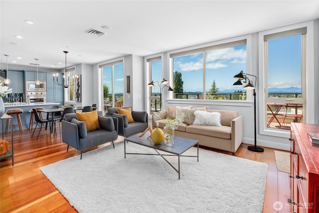 6801 Greenwood Ave N Unit 403, Seattle, WA 98103 - living room with light wood-style flooring, a chandelier, and recessed lighting