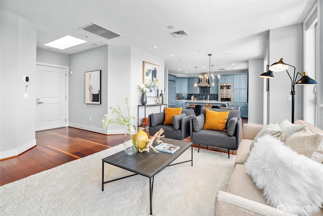 6801 Greenwood Ave N Unit 403, Seattle, WA 98103 - living area featuring hardwood / wood-style floors, a chandelier, and recessed lighting