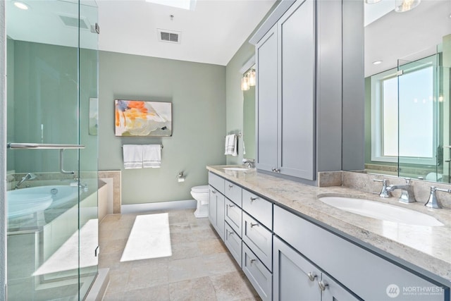 6801 Greenwood Ave N Unit 403, Seattle, WA 98103 - bathroom with double vanity, healthy amount of natural light, a shower stall, and a tub to relax in