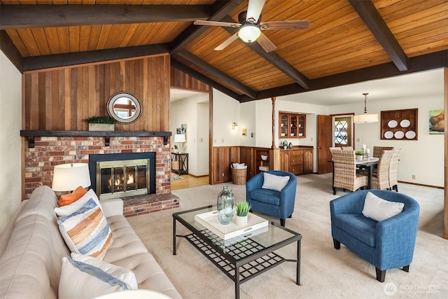 19212 94th Ave W, Edmonds, WA 98020 - living room featuring wooden ceiling, wooden walls, light carpet, a ceiling fan, and a fireplace