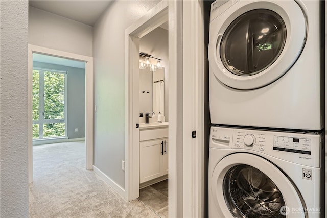 3540 S Graham St, Seattle, WA 98118 - laundry room with stacked washer / drying machine and light carpet