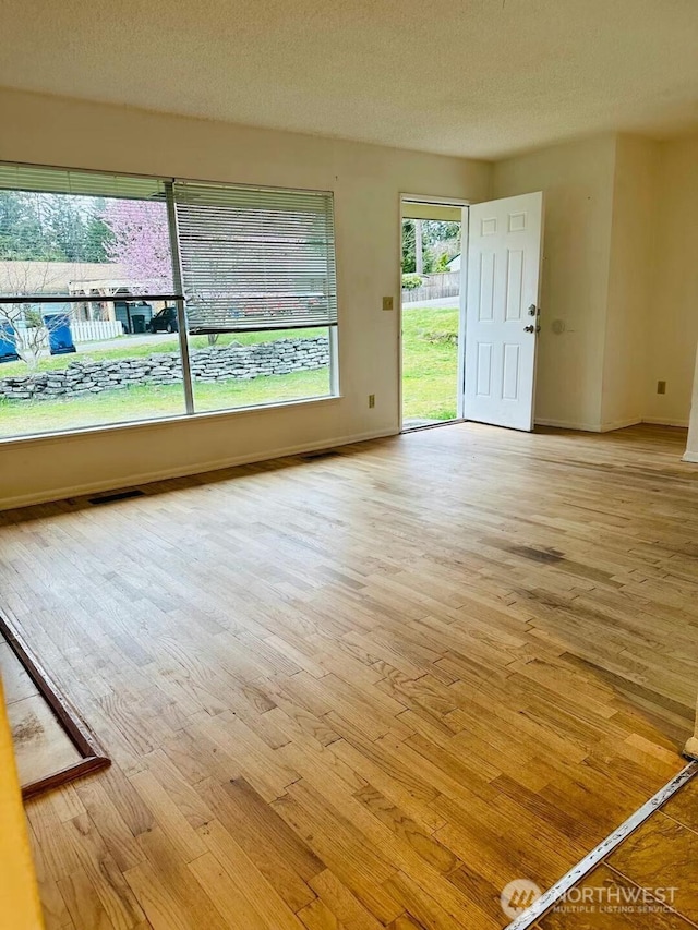 7702 202nd Pl SW, Edmonds, WA 98026 - spare room with wood-type flooring and a textured ceiling