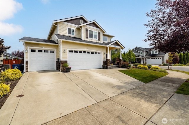 3885 Summersun St, Mount Vernon, WA 98273 - view of front facade featuring concrete driveway, an attached garage, stone siding, and a front yard