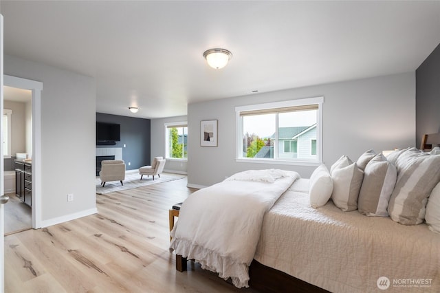 3885 Summersun St, Mount Vernon, WA 98273 - bedroom with light wood-type flooring and a tiled fireplace