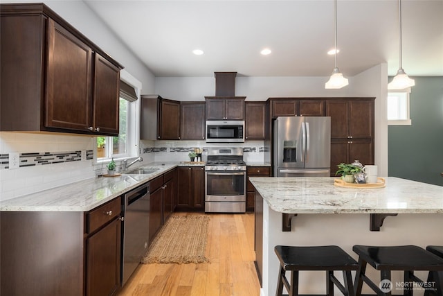 3885 Summersun St, Mount Vernon, WA 98273 - kitchen featuring stainless steel appliances, plenty of natural light, dark brown cabinets, a breakfast bar, and recessed lighting