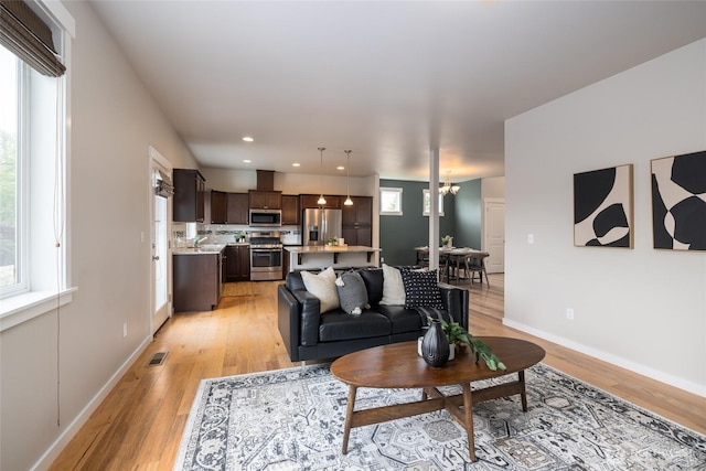 3885 Summersun St, Mount Vernon, WA 98273 - living room with light wood-style flooring, a chandelier, and recessed lighting