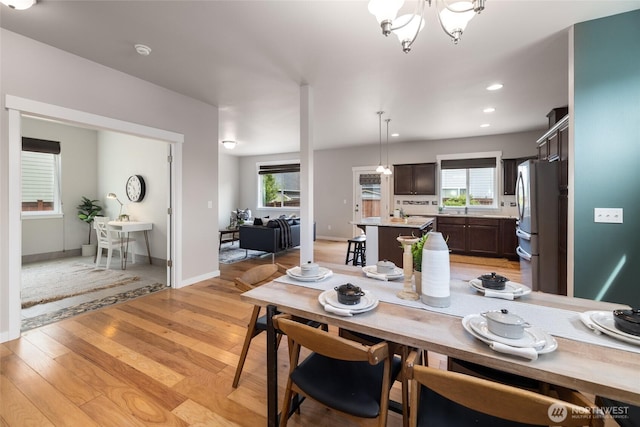 3885 Summersun St, Mount Vernon, WA 98273 - dining area with light wood finished floors, a chandelier, and recessed lighting