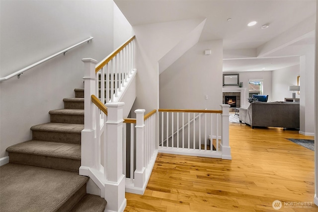 7649 NE 196th St, Kenmore, WA 98028 - stairway featuring hardwood / wood-style flooring, a tiled fireplace, and recessed lighting