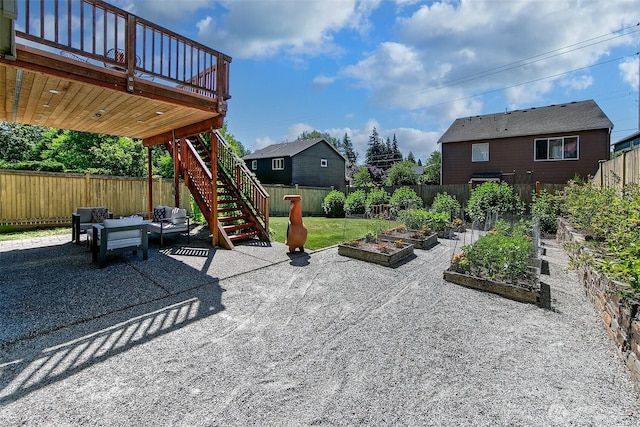 7649 NE 196th St, Kenmore, WA 98028 - fenced backyard with a vegetable garden, stairway, a patio, an outdoor hangout area, and a wooden deck