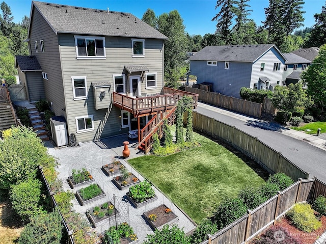 7649 NE 196th St, Kenmore, WA 98028 - rear view of house featuring stairway, a vegetable garden, a fenced backyard, a deck, and a residential view