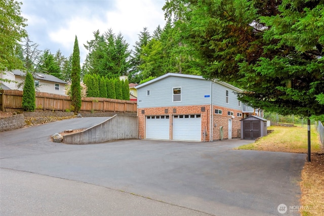 889 NE Sleepy Way, Bremerton, WA 98311 - garage with asphalt driveway and a storage shed