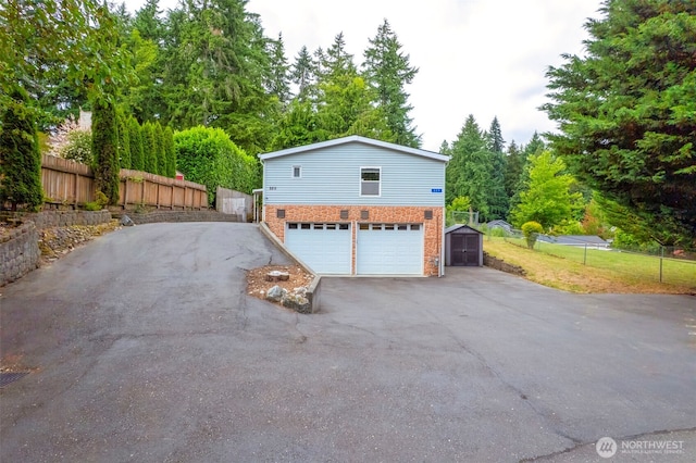 889 NE Sleepy Way, Bremerton, WA 98311 - view of home's exterior featuring asphalt driveway and brick siding