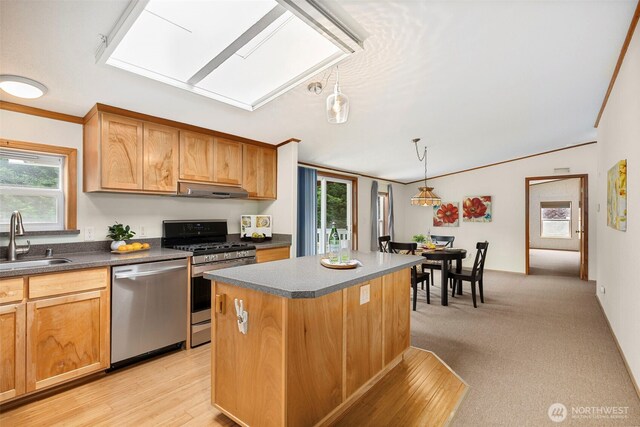889 NE Sleepy Way, Bremerton, WA 98311 - kitchen with appliances with stainless steel finishes, under cabinet range hood, dark countertops, a kitchen island, and decorative light fixtures