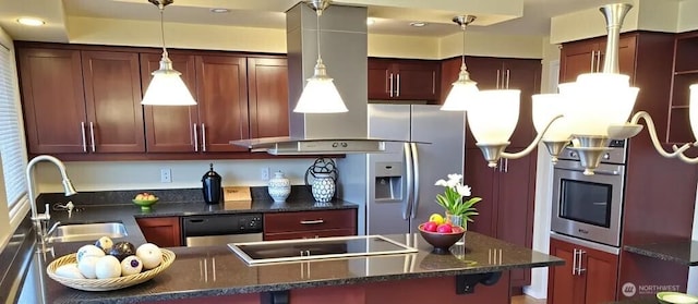 301 Norman St, Sequim, WA 98382 - kitchen featuring appliances with stainless steel finishes, pendant lighting, dark brown cabinets, dark stone countertops, and a peninsula