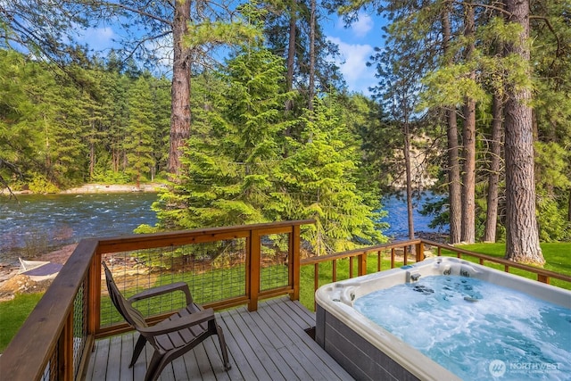 197 Swiftwater Ln, Leavenworth, WA 98826 - wooden deck with an outdoor hot tub, a water view, and a view of trees