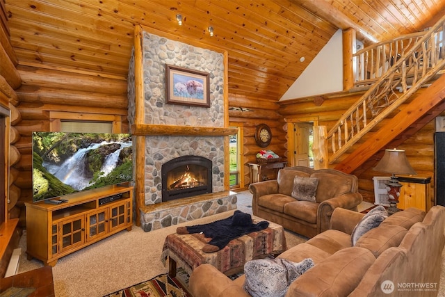 197 Swiftwater Ln, Leavenworth, WA 98826 - carpeted living room with log walls, wooden ceiling, high vaulted ceiling, stairs, and a stone fireplace