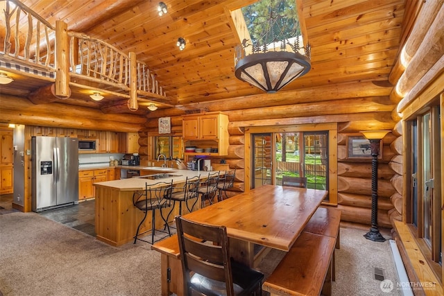 197 Swiftwater Ln, Leavenworth, WA 98826 - dining room featuring dark carpet, high vaulted ceiling, wood ceiling, and rustic walls