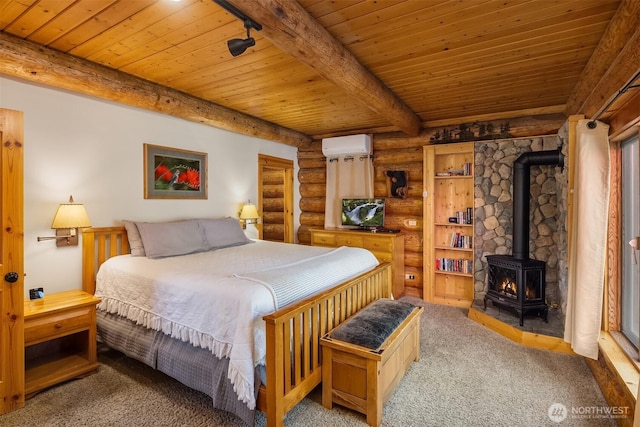 197 Swiftwater Ln, Leavenworth, WA 98826 - carpeted bedroom featuring log walls, a wood stove, a wood ceiling with exposed beams, and a wall mounted AC