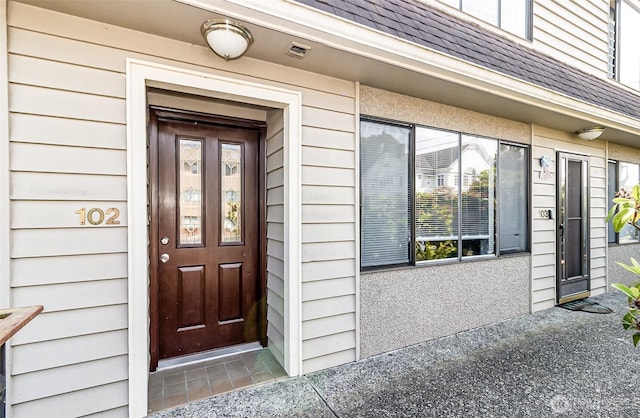 1612 33rd St Unit 102, Everett, WA 98201 - view of exterior entry featuring roof with shingles
