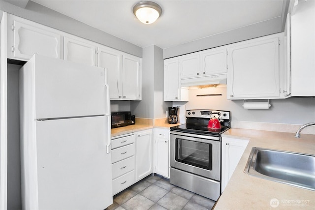 1612 33rd St Unit 102, Everett, WA 98201 - kitchen with freestanding refrigerator, stainless steel electric range, under cabinet range hood, black microwave, and light countertops