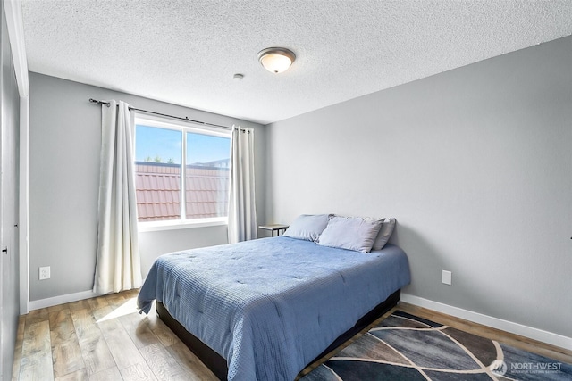 1612 33rd St Unit 102, Everett, WA 98201 - bedroom featuring wood finished floors and a textured ceiling