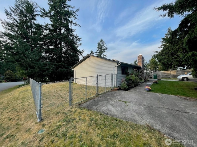 12611 50th Dr SE, Everett, WA 98208 - view of property exterior with a chimney, asphalt driveway, and a gate