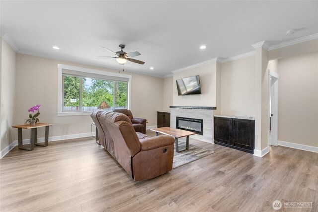 225 N Mcneely St, Buckley, WA 98321 - living room with a glass covered fireplace, light wood finished floors, a ceiling fan, ornamental molding, and recessed lighting