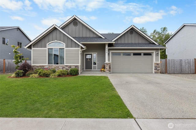 225 N Mcneely St, Buckley, WA 98321 - craftsman-style house with board and batten siding, stone siding, a garage, concrete driveway, and a shingled roof