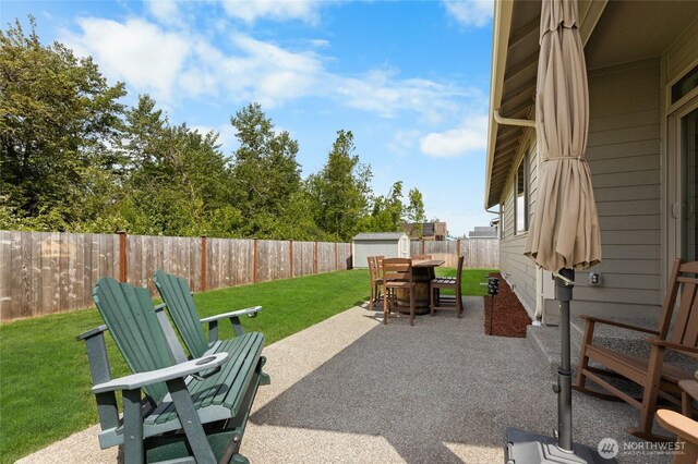 225 N Mcneely St, Buckley, WA 98321 - fenced backyard with a storage shed, outdoor dining space, and a patio area