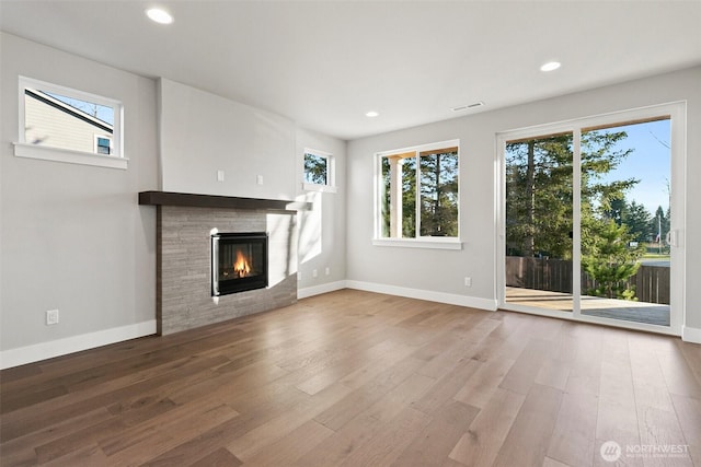15705LOT13 SE 257th St, Covington, WA 98042 - unfurnished living room with a glass covered fireplace, wood finished floors, and recessed lighting