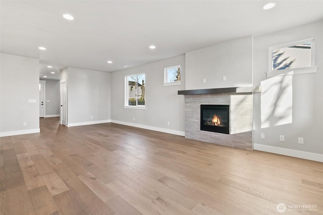 15705LOT13 SE 257th St, Covington, WA 98042 - unfurnished living room featuring wood finished floors, a glass covered fireplace, and recessed lighting
