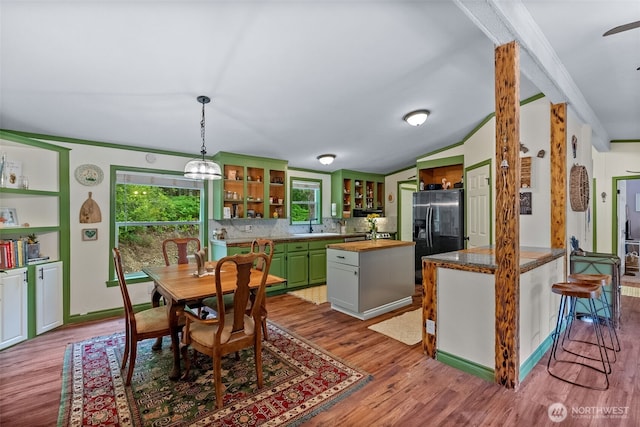 12543 Bear Track Ln SW, Port Orchard, WA 98367 - kitchen with green cabinets, open shelves, black fridge with ice dispenser, wood finished floors, and crown molding