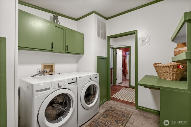 12543 Bear Track Ln SW, Port Orchard, WA 98367 - laundry room featuring cabinet space, washer and clothes dryer, and wood finished floors