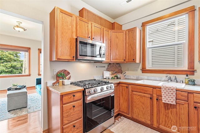 1007 N Forest St, Bellingham, WA 98225 - kitchen featuring appliances with stainless steel finishes, light countertops, and light wood finished floors