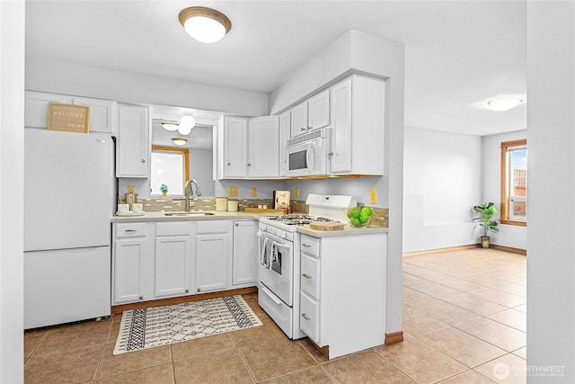 1007 N Forest St, Bellingham, WA 98225 - kitchen with white appliances, light countertops, light tile patterned floors, and white cabinets