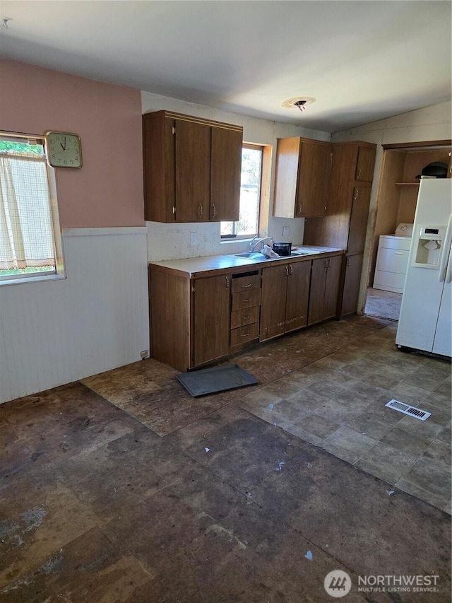 111 99th St S Unit 14, Tacoma, WA 98444 - kitchen with washer / clothes dryer, wainscoting, light countertops, and white refrigerator with ice dispenser