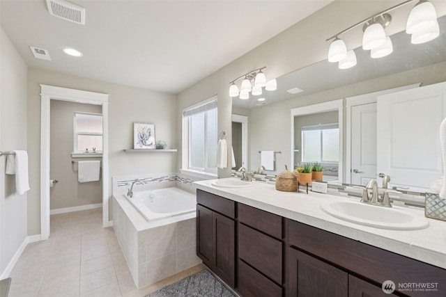 20402 1st Pl W, Lynnwood, WA 98036 - full bathroom with double vanity, healthy amount of natural light, a garden tub, and tile patterned floors