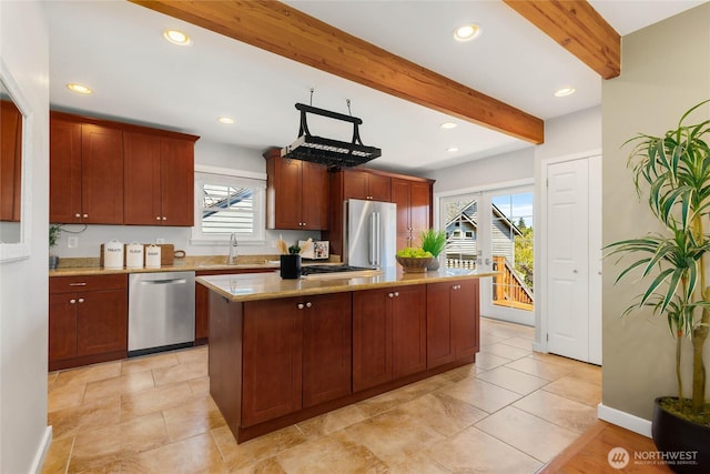 1628 27th Ave, Seattle, WA 98122 - kitchen featuring stainless steel appliances, beam ceiling, recessed lighting, a center island, and light stone countertops