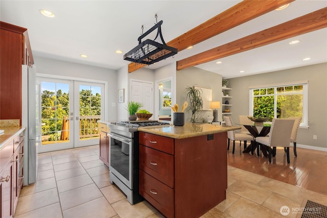 1628 27th Ave, Seattle, WA 98122 - kitchen featuring gas range, recessed lighting, light stone countertops, a center island, and beam ceiling