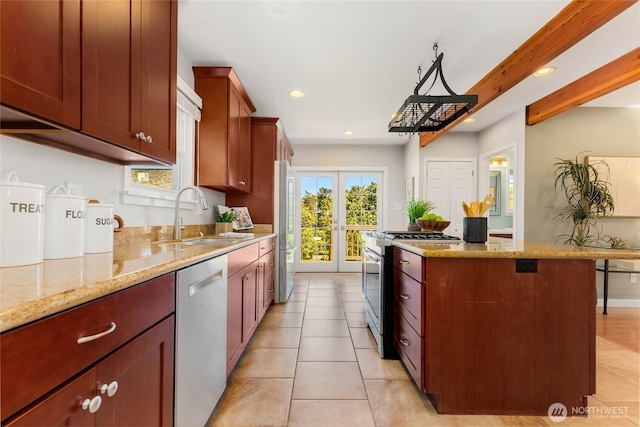 1628 27th Ave, Seattle, WA 98122 - kitchen featuring stainless steel appliances, recessed lighting, a center island, light stone countertops, and light tile patterned floors