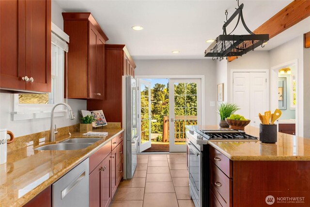 1628 27th Ave, Seattle, WA 98122 - kitchen featuring stainless steel appliances, recessed lighting, light tile patterned floors, a center island, and light stone countertops