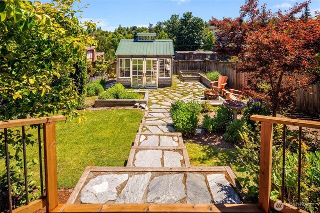 1628 27th Ave, Seattle, WA 98122 - fenced backyard with a garden, an outdoor structure, and an outdoor fire pit