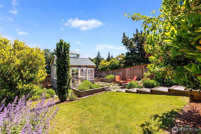 1628 27th Ave, Seattle, WA 98122 - fenced backyard featuring a garden, an outdoor structure, and a greenhouse