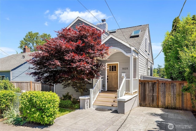 1628 27th Ave, Seattle, WA 98122 - view of front of home featuring a chimney and roof with shingles
