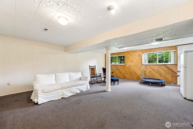 9317 214th Ave E, Bonney Lake, WA 98391 - carpeted living room featuring wooden walls