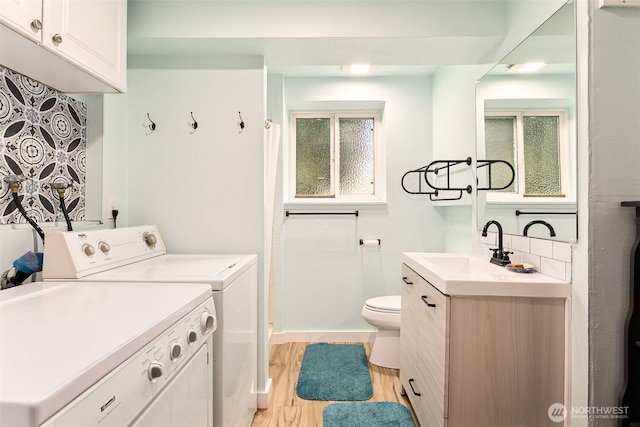 9317 214th Ave E, Bonney Lake, WA 98391 - full bathroom with washer and clothes dryer, vanity, wood finished floors, and decorative backsplash